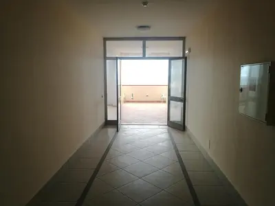 an empty hallway with an open door to a room at Casavacanze corallo in Isola delle Femmine