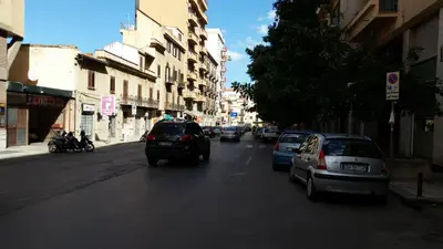 a group of cars parked on a city street at Hostel Tribunale Room Basement in Palermo