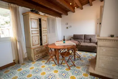 a living room with a table and a couch at Liberty house in Castellammare del Golfo