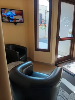 a waiting room with two chairs and a window at Amaryllis Hotel in San Vito lo Capo