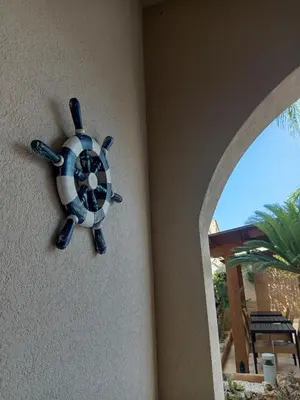 a blue and white clock on the side of a wall at Amaryllis Hotel in San Vito lo Capo