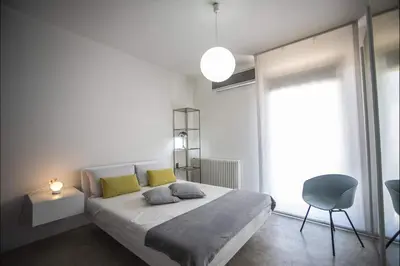 a bedroom with a large bed with yellow pillows at Villa Corallo in Cinisi