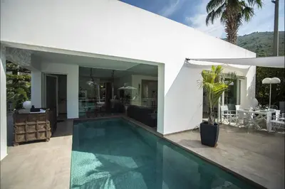 a swimming pool in front of a house at Villa Corallo in Cinisi