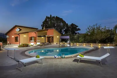 a swimming pool in front of a house at Villa Thyrrenia in Castellammare del Golfo