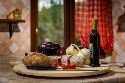 a cutting board with vegetables and a bottle of wine at Villa Thyrrenia in Castellammare del Golfo
