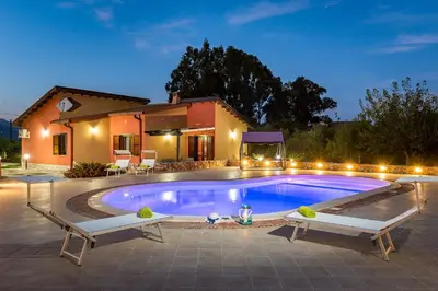 a swimming pool in front of a house at Villa Thyrrenia in Castellammare del Golfo