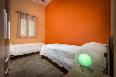 a room with two beds and a green ball on a table at Villa Gea in Castellammare del Golfo