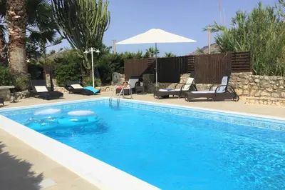 a swimming pool with a blue pool noodle in it at Villa Isabella in Castellammare del Golfo