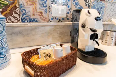a coffee maker and a basket on a counter at VILLA ROSETTA ampi spazi esterni WIFI FREE in Trabia