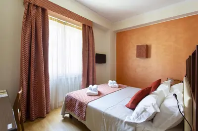 a hotel room with a bed and a window at Residenza Wagner in Palermo