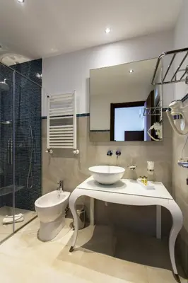 a bathroom with a sink and a toilet and a mirror at Residenza Wagner in Palermo