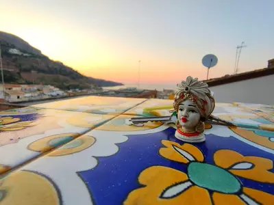 a view of the ocean from a city at sunset at Case Vacanze Gabry in Castellammare del Golfo