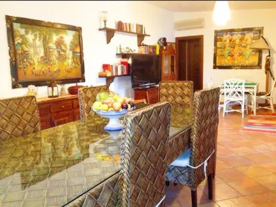 a living room with a table with a bowl of fruit at RUMAH SAYA in Campofelice di Roccella