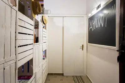 a hallway with a white door and a chalkboard on the wall at Amunì in Palermo