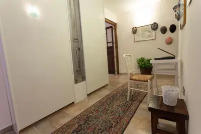 a hallway with a door and a table and a chair at Amunì in Palermo
