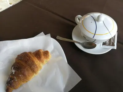 a pastry and a cup of coffee on a table at Amunì in Palermo