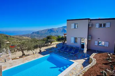 a villa with a swimming pool next to a house at Villa Montemar in Balata di Baida