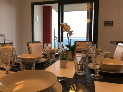 a long table with plates and glasses on it at Red Luxury in Borgo Guardiola near Cefalù in Mandra Capreria