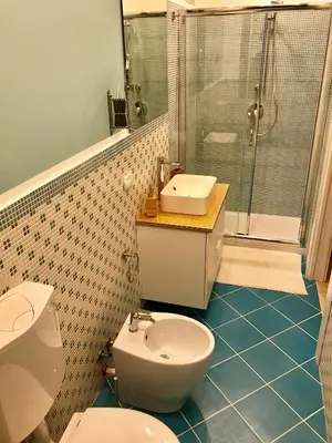 a bathroom with a toilet and a sink and a shower at Red Luxury in Borgo Guardiola near Cefalù in Mandra Capreria