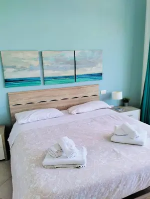 a bed with towels on top of it with a window at Red Luxury in Borgo Guardiola near Cefalù in Mandra Capreria