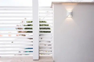 a sliding glass door with plants on it at Casa Azzurra sul mare e centralissima in San Vito lo Capo