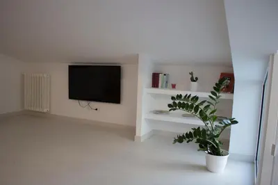 a living room with a tv and a potted plant at Duchessa House in Castellammare del Golfo