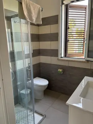 two beds in a small room with a window at Residence le Coccinelle vicino a Cefalù in Campofelice di Roccella