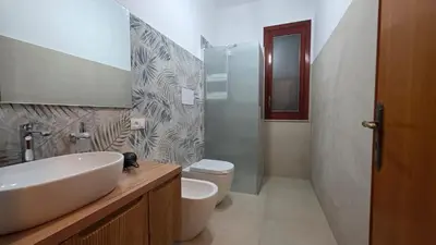 a bathroom with a sink and a toilet and a shower at Residence le Coccinelle vicino a Cefalù in Campofelice di Roccella