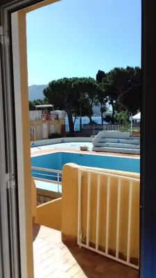 a view of a swimming pool from a window at Suites Mondello Deluxe in Mondello