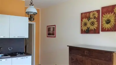a kitchen with two pictures of sunflowers on the wall at Suites Mondello Deluxe in Mondello