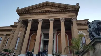 a large building with columns in front of it at Cocciu d'amuri Central Apartment Spacious and Comfortable in Palermo