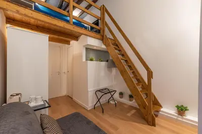 a living room with a loft with a staircase at Casa Abbanniata a Ballaro' by Wonderful Italy in Palermo