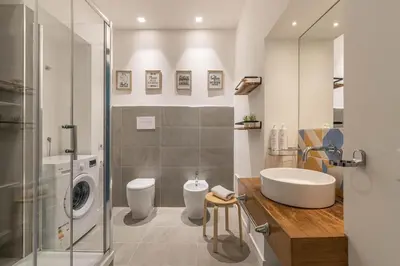 a bathroom with a sink and a washing machine at Casa Abbanniata a Ballaro' by Wonderful Italy in Palermo
