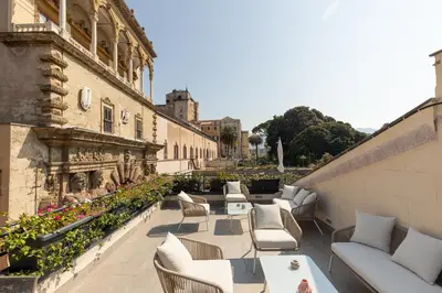 a patio with tables and chairs on a building at I Mori di Porta Nuova Suite & Terrace in Palermo