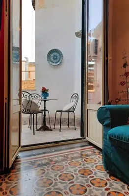 a living room with a table and chairs on a patio at Le terrazze segrete in Palermo