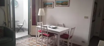 a small white table and chairs in a room at Le terrazze segrete in Palermo
