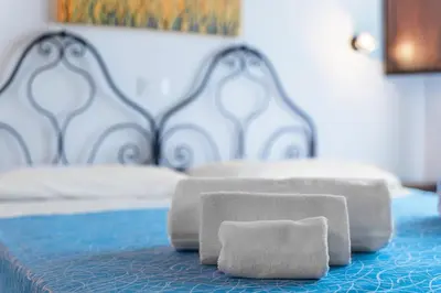 a pair of towels sitting on top of a bed at Casale Ginisara in Castellammare del Golfo
