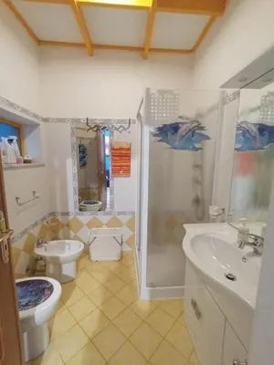 a bathroom with a sink and a toilet and a shower at Casa 