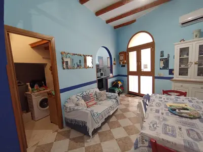 a blue room with a bed and a table at Casa 