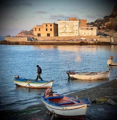 a man walking on a boat in the water at Casa 