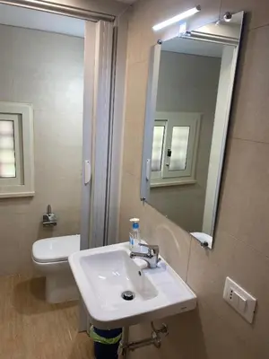 a bathroom with a sink and a toilet and a mirror at Tiny House Basilio in Palermo