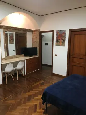 a bedroom with a bed and a desk with a computer at Tiny House Basilio in Palermo
