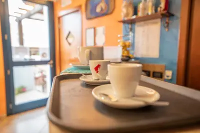 two cups and saucers sitting on a tray at Hotel Altamarea in San Vito lo Capo