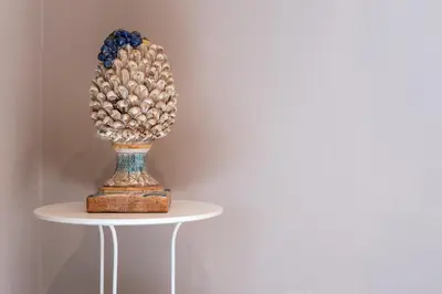 a trophy sitting on a table with a white wall at Qasr Home Beautiful apartment in Palermo in Palermo