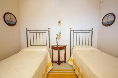 two beds sitting next to each other in a room at Solemar Sicilia - Casa Porto Bagnera in Santa Flavia