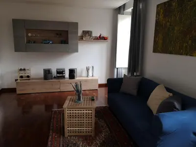 a living room with a blue couch and a table at A casa di Zara in Termini Imerese