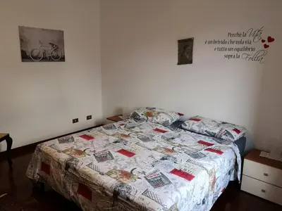 a bed with a quilt on it in a bedroom at A casa di Zara in Termini Imerese