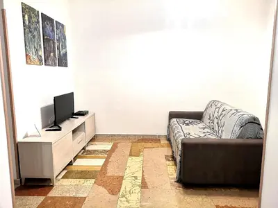 a living room with a couch and a flat screen tv at I babbaluci in Palermo