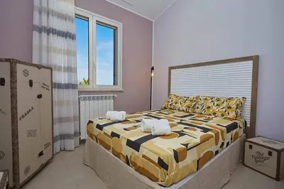 a bedroom with a bed with two towels on it at Villa Biancolilla in Castellammare del Golfo