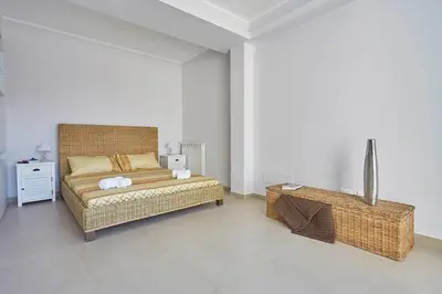 a bedroom with a large bed and a table at Villa Biancolilla in Castellammare del Golfo